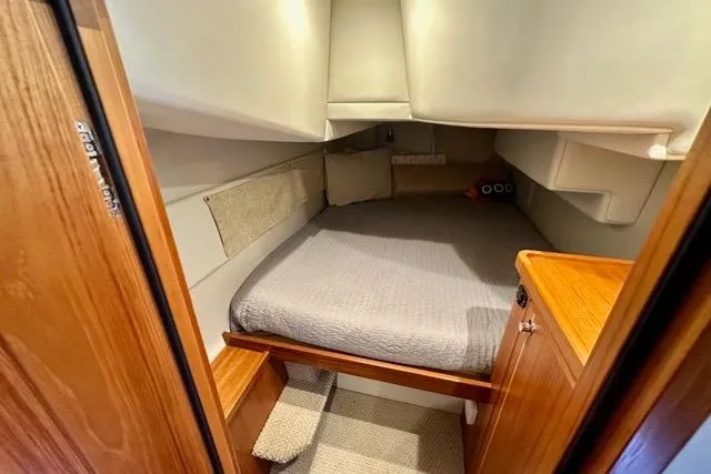 Topcat Yacht Photos Pics 2022 Aspen C120 boat cabin with cozy bed and wooden interior.