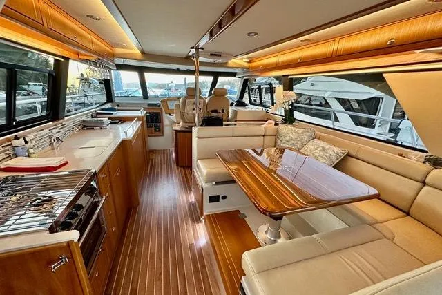 Topcat Yacht Photos Pics Luxurious interior of 2022 Aspen C120 yacht with elegant wood finishes and spacious seating.
