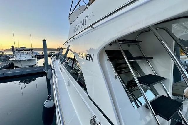 Topcat Yacht Photos Pics 2022 Aspen C120 yacht docked at sunset, showcasing sleek design and modern features.