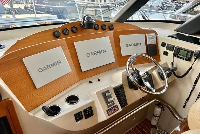 Topcat Yacht Photos Pics 2022 Aspen C120 boat dashboard with Garmin navigation displays and steering wheel.