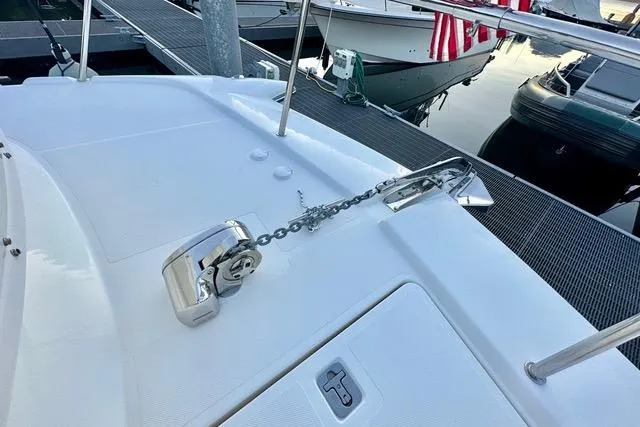 Topcat Yacht Photos Pics 2022 Aspen C120 boat deck with anchor chain and winch at marina.