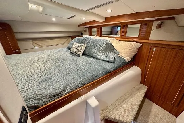 Topcat Yacht Photos Pics Luxurious cabin interior of 2022 Aspen C120 yacht with cozy bedding and wooden accents.