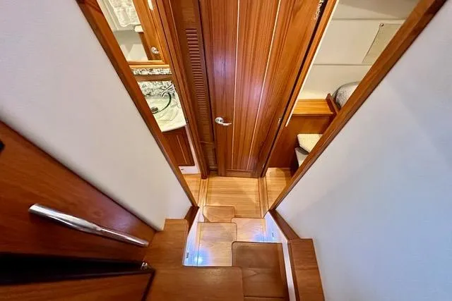 Topcat Yacht Photos Pics Interior of 2022 Aspen C120 yacht with wooden stairs and door.