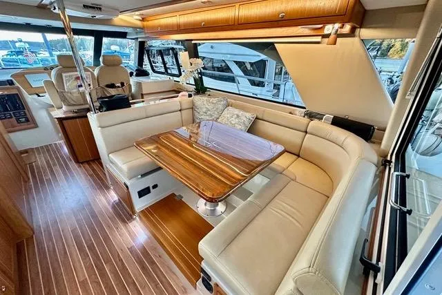 Topcat Yacht Photos Pics Luxurious interior of 2022 Aspen C120 yacht with elegant seating and wooden table.
