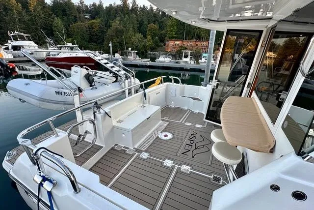 Topcat Yacht Photos Pics Aspen C120 2022 model boat deck with seating, docked at marina.