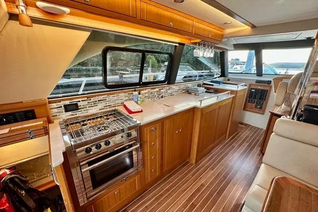 Topcat Yacht Photos Pics Luxurious 2022 Aspen C120 yacht interior with modern kitchen and elegant wood finishes.