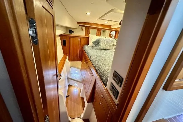 Topcat Yacht Photos Pics Luxurious 2022 Aspen C120 yacht interior with wood finish and cozy sleeping area.