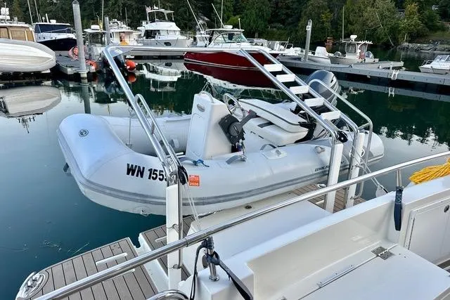 Topcat Yacht Photos Pics 2022 Aspen C120 inflatable boat docked at a marina with other vessels.