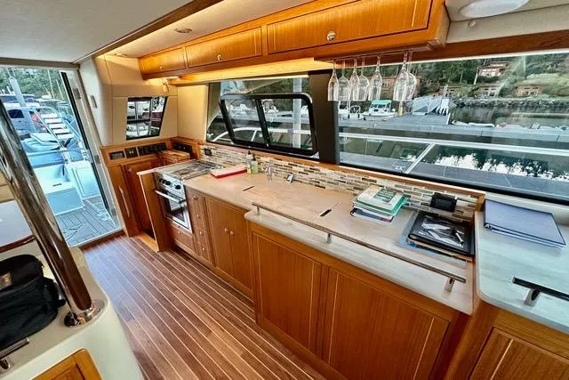 Topcat Yacht Photos Pics Luxurious 2022 Aspen C120 yacht interior with modern kitchen and scenic window view.