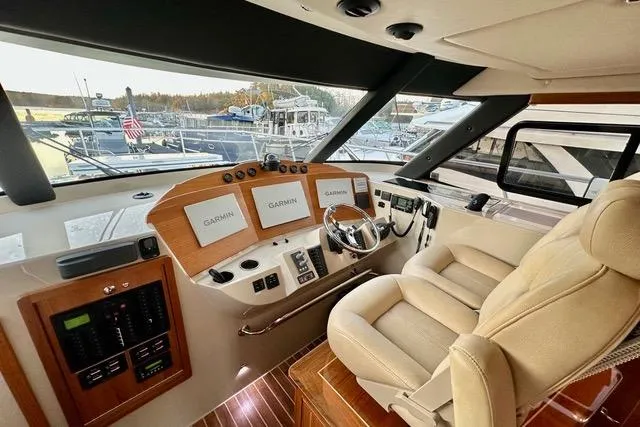 Topcat Yacht Photos Pics Luxurious 2022 Aspen C120 yacht cockpit with Garmin navigation displays and plush seating.