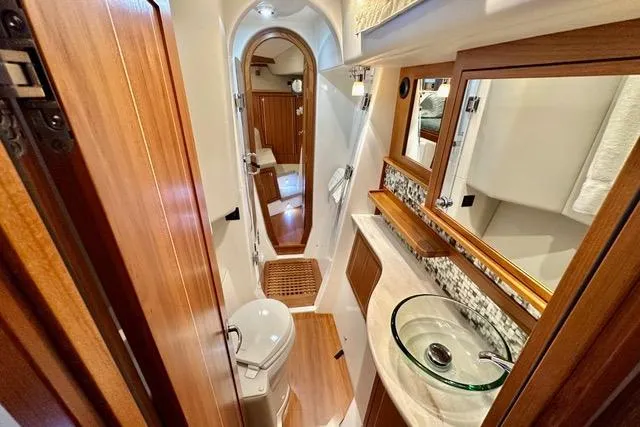 Topcat Yacht Photos Pics Luxurious 2022 Aspen C120 yacht bathroom with modern fixtures and elegant wood accents.