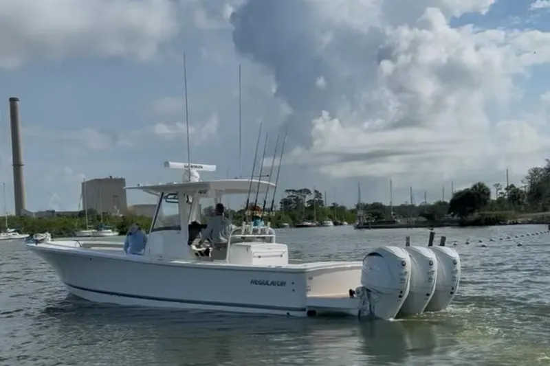 34 Regulator Yacht Photos Pics 2024 Regulator 34 C boat on water with twin engines and fishing rods.