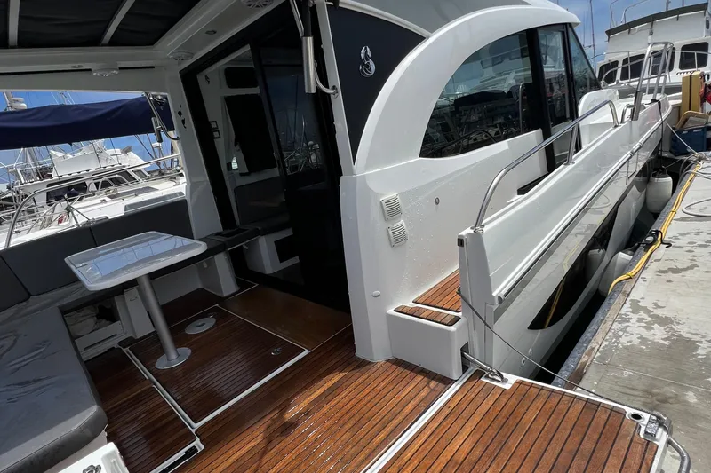 Seawalkin Yacht Photos Pics 2022 Beneteau Antares 11 yacht docked, featuring sleek design and spacious deck area.