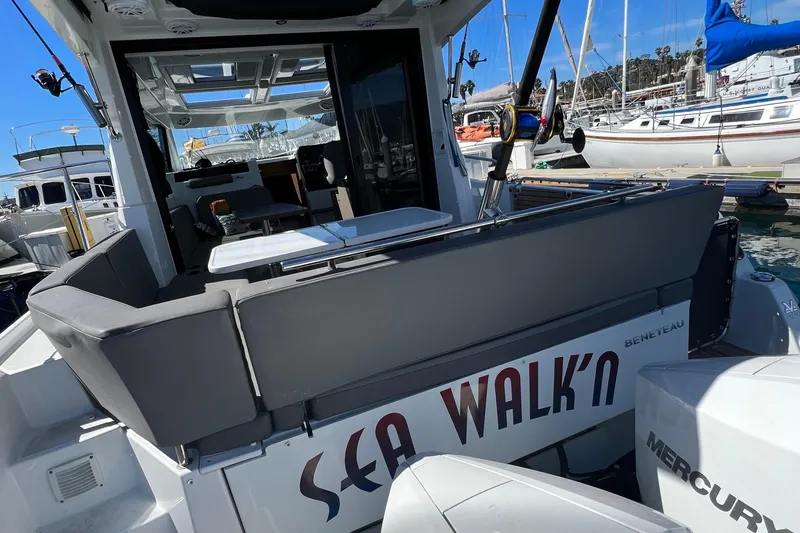 Seawalkin Yacht Photos Pics 2022 Beneteau Antares 11 boat docked, featuring spacious seating and modern design.