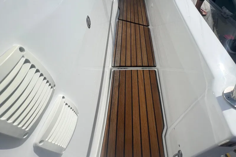 Seawalkin Yacht Photos Pics Teak deck of 2022 Beneteau Antares 11 boat, featuring sleek white interior.
