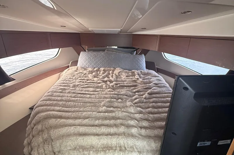 Seawalkin Yacht Photos Pics 2022 Beneteau Antares 11 cabin interior with cozy bed and modern design.