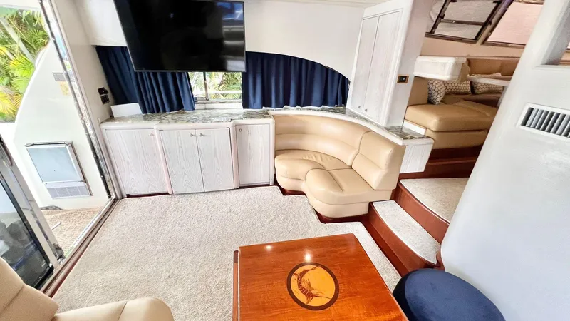  Yacht Photos Pics Luxurious interior of 1995 Neptunus 58 Flybridge yacht with plush seating and elegant decor.