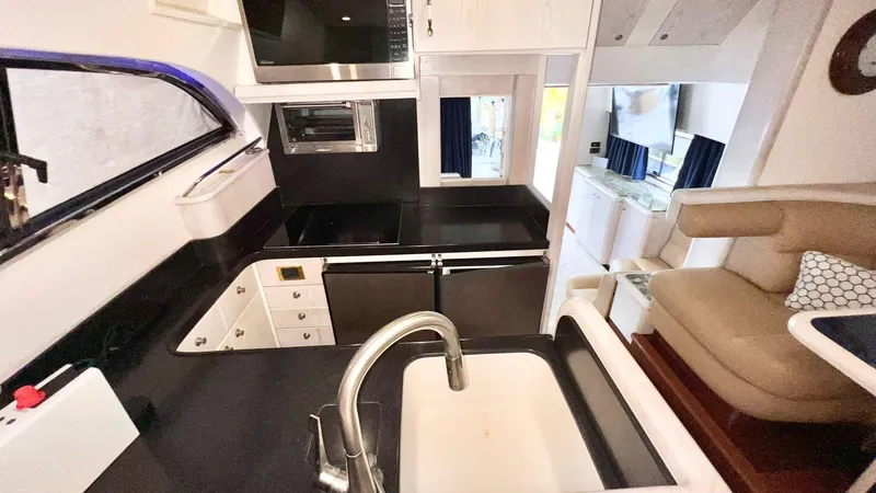  Yacht Photos Pics 1995 Neptunus 58 Flybridge yacht kitchen with modern appliances and sleek design.