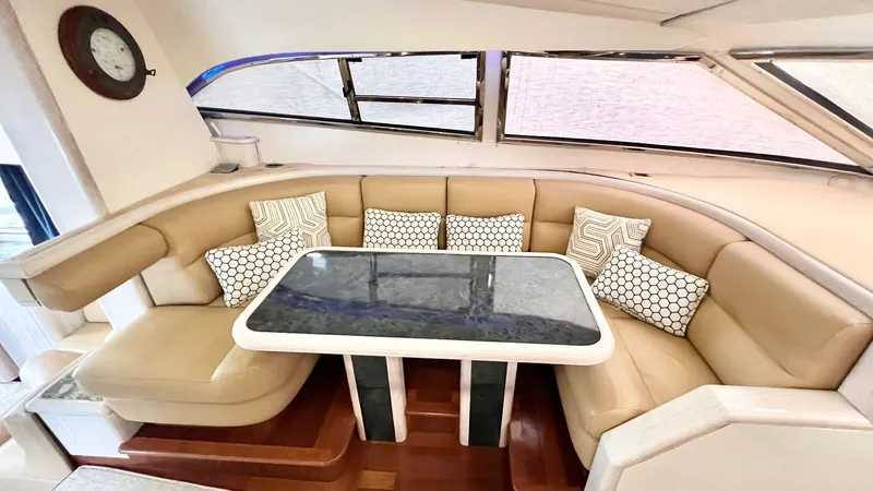  Yacht Photos Pics Luxurious Neptunus 58 Flybridge 1995 yacht interior with elegant seating and table.