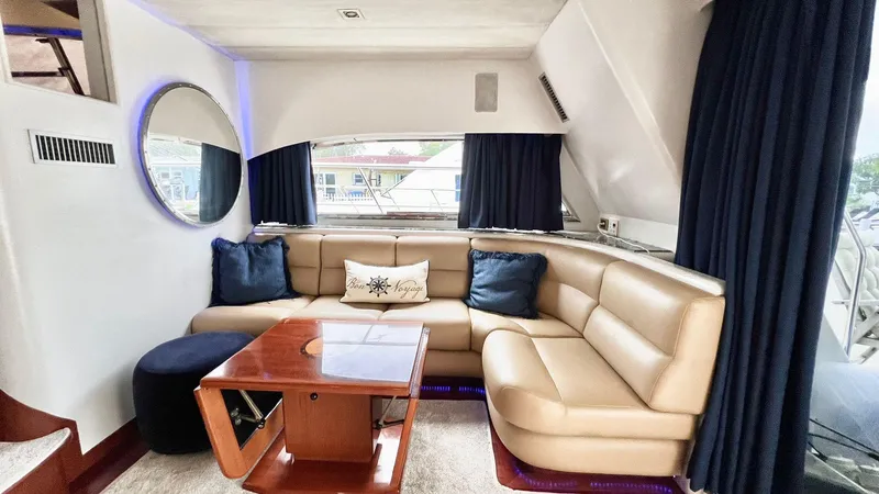  Yacht Photos Pics Luxurious 1995 Neptunus 58 Flybridge yacht interior with leather seating and elegant decor.