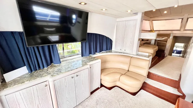  Yacht Photos Pics Luxurious interior of 1995 Neptunus 58 Flybridge yacht with TV and seating area.