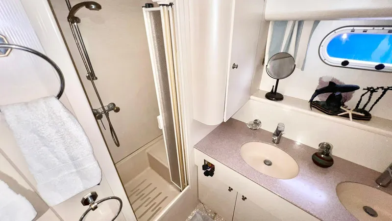  Yacht Photos Pics Luxurious bathroom in 1995 Neptunus 58 Flybridge yacht with shower and vanity.