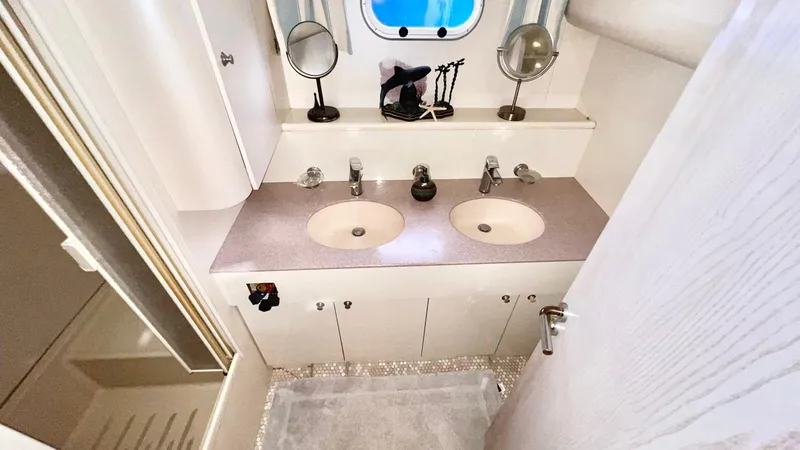  Yacht Photos Pics Luxurious bathroom in 1995 Neptunus 58 Flybridge yacht with dual sinks and elegant fixtures.