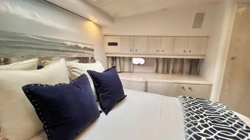  Yacht Photos Pics Luxurious bedroom interior of 1995 Neptunus 58 Flybridge yacht with elegant decor.