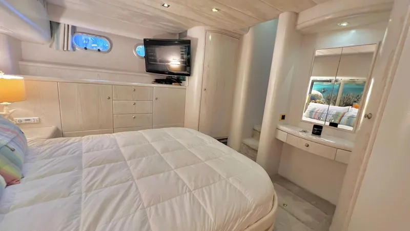  Yacht Photos Pics Luxurious 1995 Neptunus 58 Flybridge yacht bedroom with elegant furnishings and modern amenities.