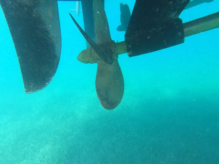  Yacht Photos Pics Underwater view of Neptunus 58 Flybridge 1995 propeller in clear blue water.
