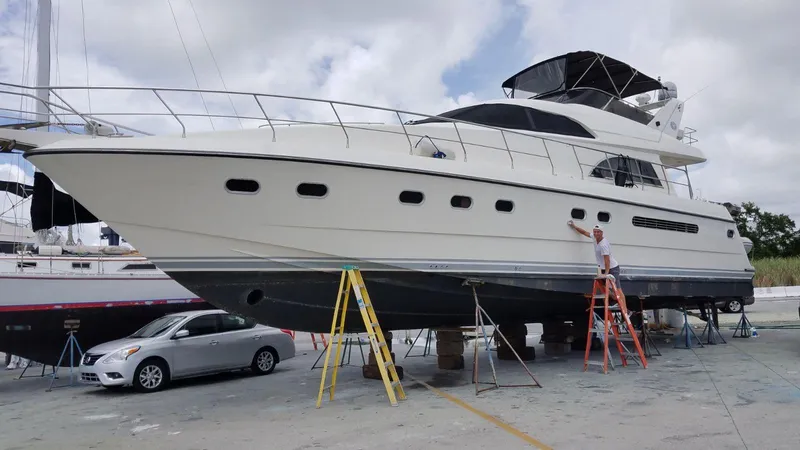  Yacht Photos Pics 1995 Neptunus 58 Flybridge yacht on dry dock with maintenance work in progress.