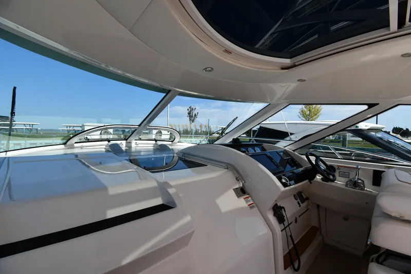 Land Shark Yacht Photos Pics Interior view of 2010 Sea Ray 450 Sundancer yacht cockpit with modern controls and seating.