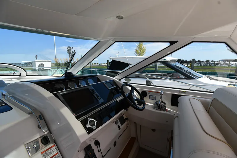 Land Shark Yacht Photos Pics Interior view of 2010 Sea Ray 450 Sundancer yacht cockpit with steering wheel and controls.