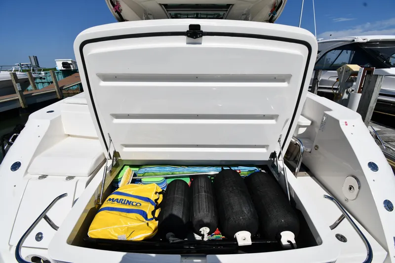 Land Shark Yacht Photos Pics Open storage compartment on 2010 Sea Ray 450 Sundancer boat, containing marine equipment and accessories.