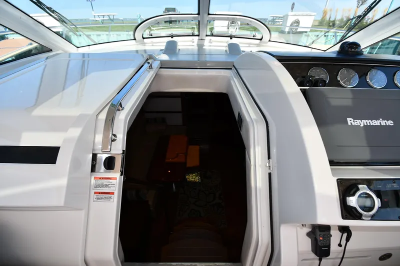 Land Shark Yacht Photos Pics 2010 Sea Ray 450 Sundancer cockpit with Raymarine navigation system and cabin entrance.