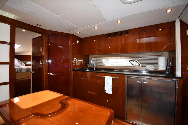 Land Shark Yacht Photos Pics Luxurious interior of 2010 Sea Ray 450 Sundancer yacht with modern kitchen amenities.