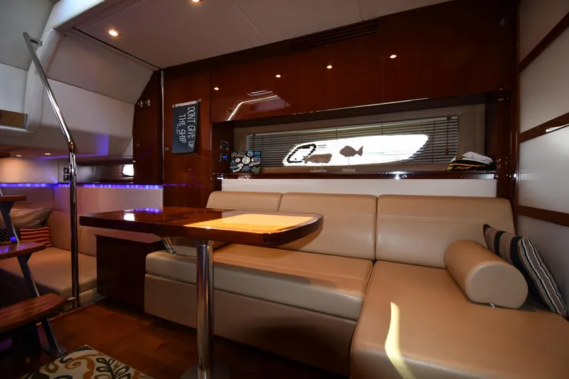 Land Shark Yacht Photos Pics Luxurious interior of 2010 Sea Ray 450 Sundancer yacht with leather seating and wooden table.