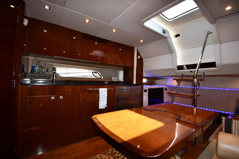 Land Shark Yacht Photos Pics Luxurious interior of 2010 Sea Ray 450 Sundancer yacht with modern kitchen and seating area.