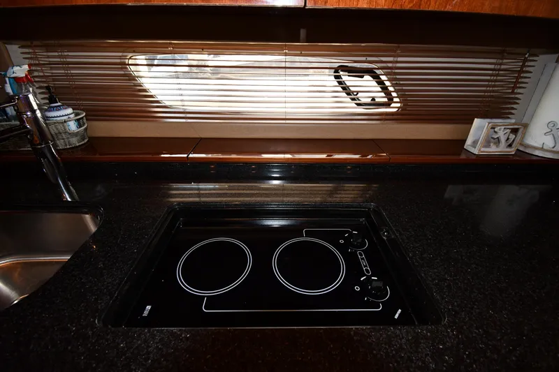 Land Shark Yacht Photos Pics Modern kitchen in 2010 Sea Ray 450 Sundancer yacht with sleek cooktop and window blinds.