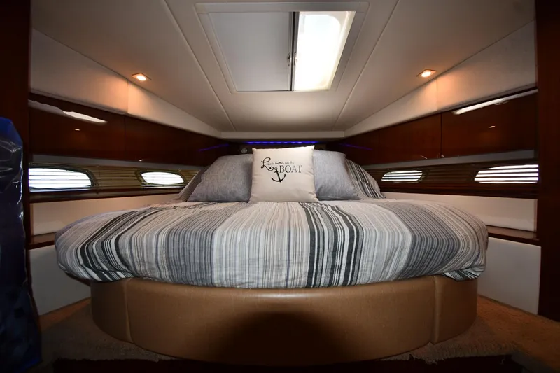 Land Shark Yacht Photos Pics Luxurious cabin interior of 2010 Sea Ray 450 Sundancer yacht with cozy bed.