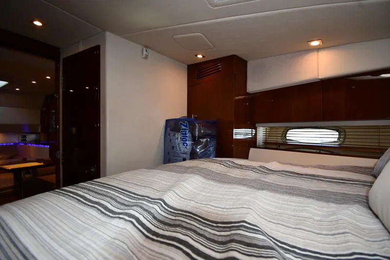 Land Shark Yacht Photos Pics Interior cabin of 2010 Sea Ray 450 Sundancer yacht with striped bedding.