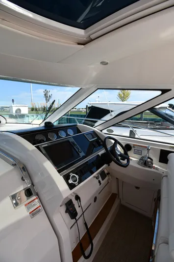 Land Shark Yacht Photos Pics Interior cockpit of 2010 Sea Ray 450 Sundancer yacht with modern controls and steering.