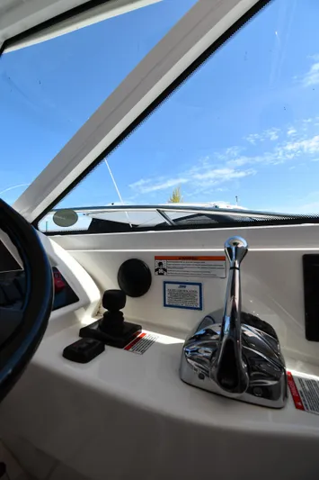 Land Shark Yacht Photos Pics Interior view of 2010 Sea Ray 450 Sundancer helm with controls and clear sky.