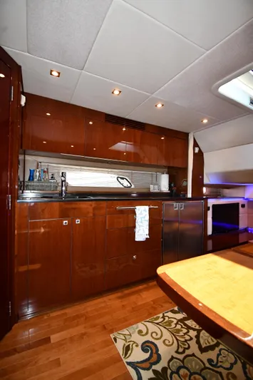Land Shark Yacht Photos Pics Luxurious interior of 2010 Sea Ray 450 Sundancer yacht with modern kitchen amenities.