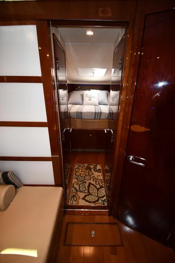 Land Shark Yacht Photos Pics Interior view of 2010 Sea Ray 450 Sundancer yacht cabin with bed and decorative rug.