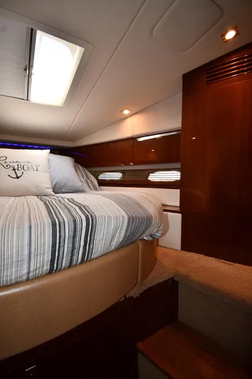 Land Shark Yacht Photos Pics Interior cabin of 2010 Sea Ray 450 Sundancer with bed and wooden accents.