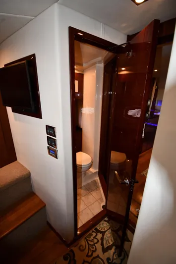 Land Shark Yacht Photos Pics Interior of 2010 Sea Ray 450 Sundancer yacht, featuring a compact bathroom with wooden door.