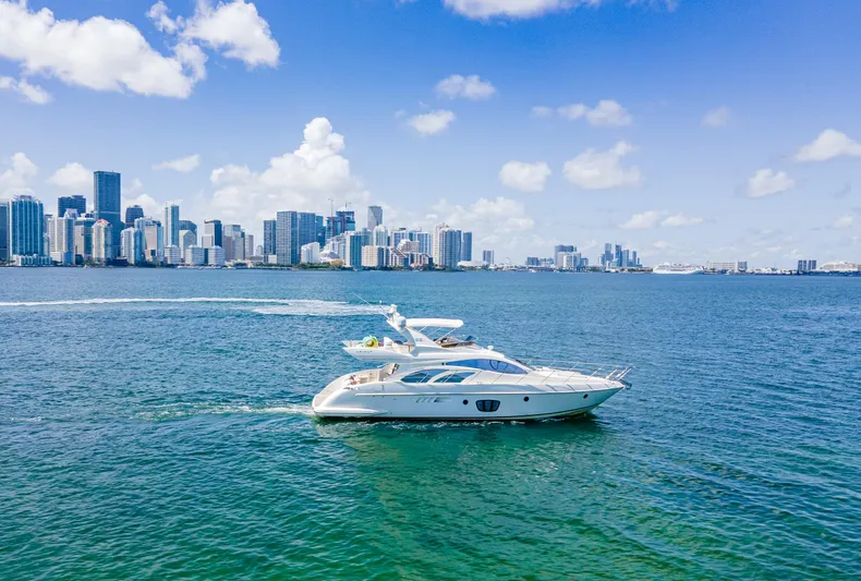  Yacht Photos Pics 2005 Azimut 55E yacht cruising near a city skyline under a clear blue sky.