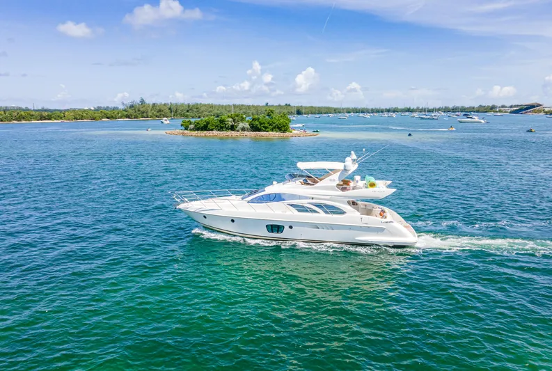  Yacht Photos Pics 2005 Azimut 55E yacht cruising on clear blue waters under a sunny sky.