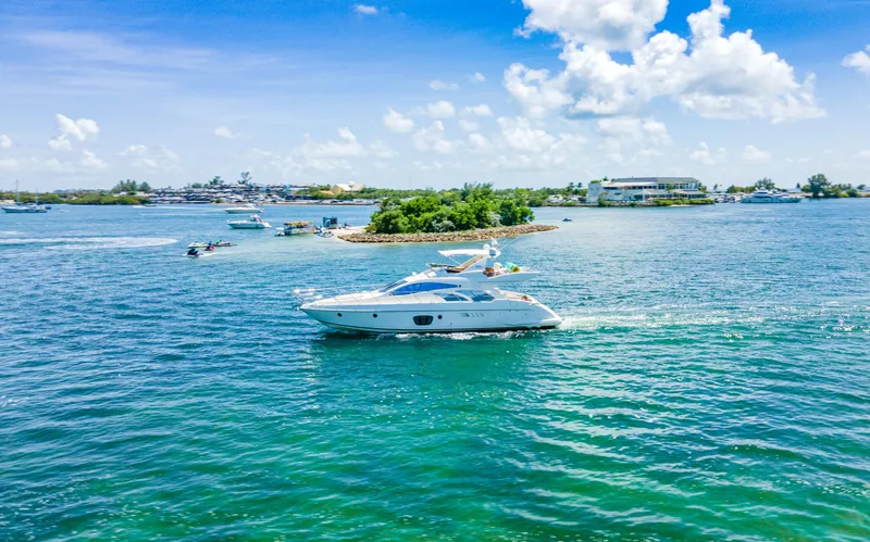  Yacht Photos Pics Azimut 55E yacht cruising on clear blue waters, 2005 model, under a sunny sky.